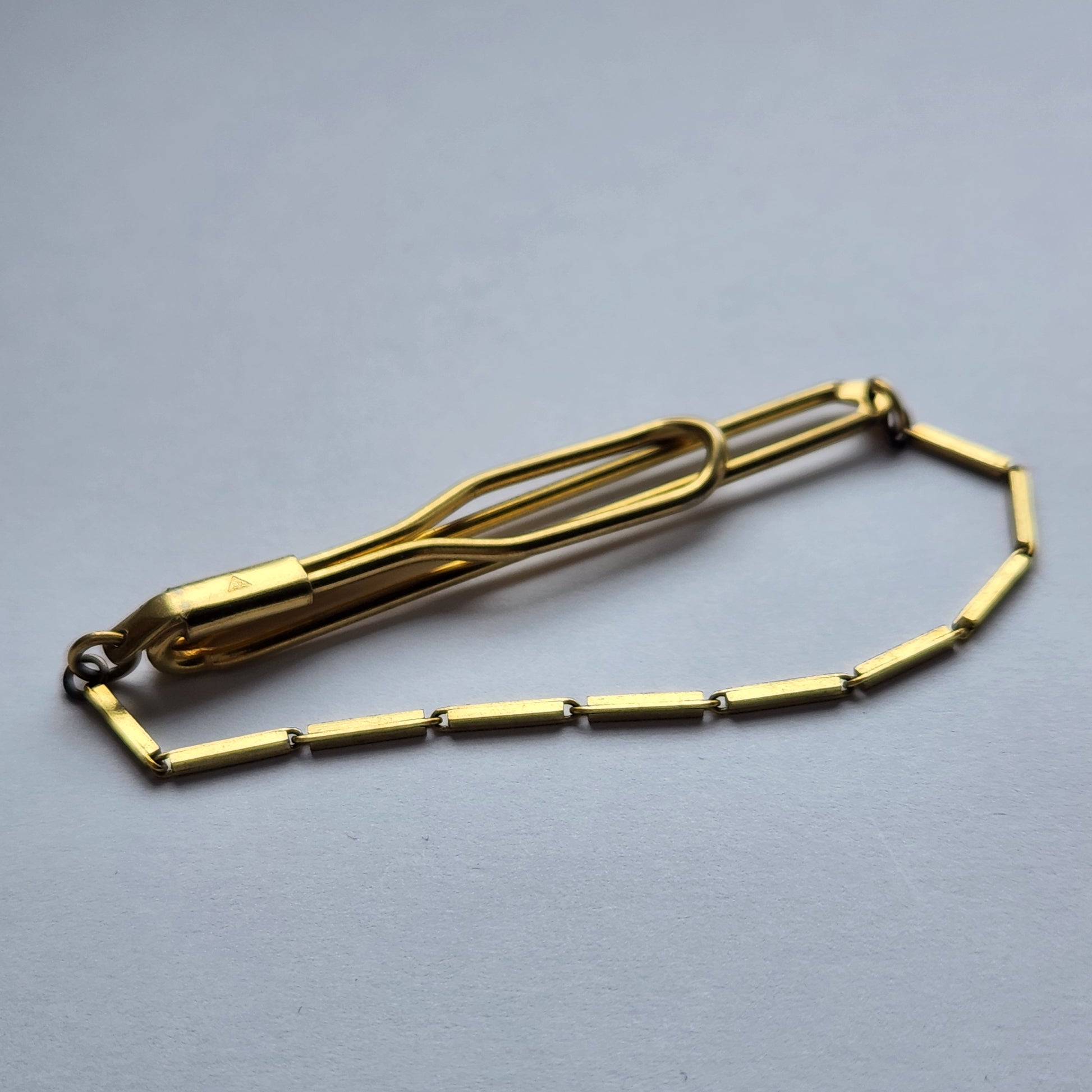 TEKA gold-tone tie clip, showing its vintage design.