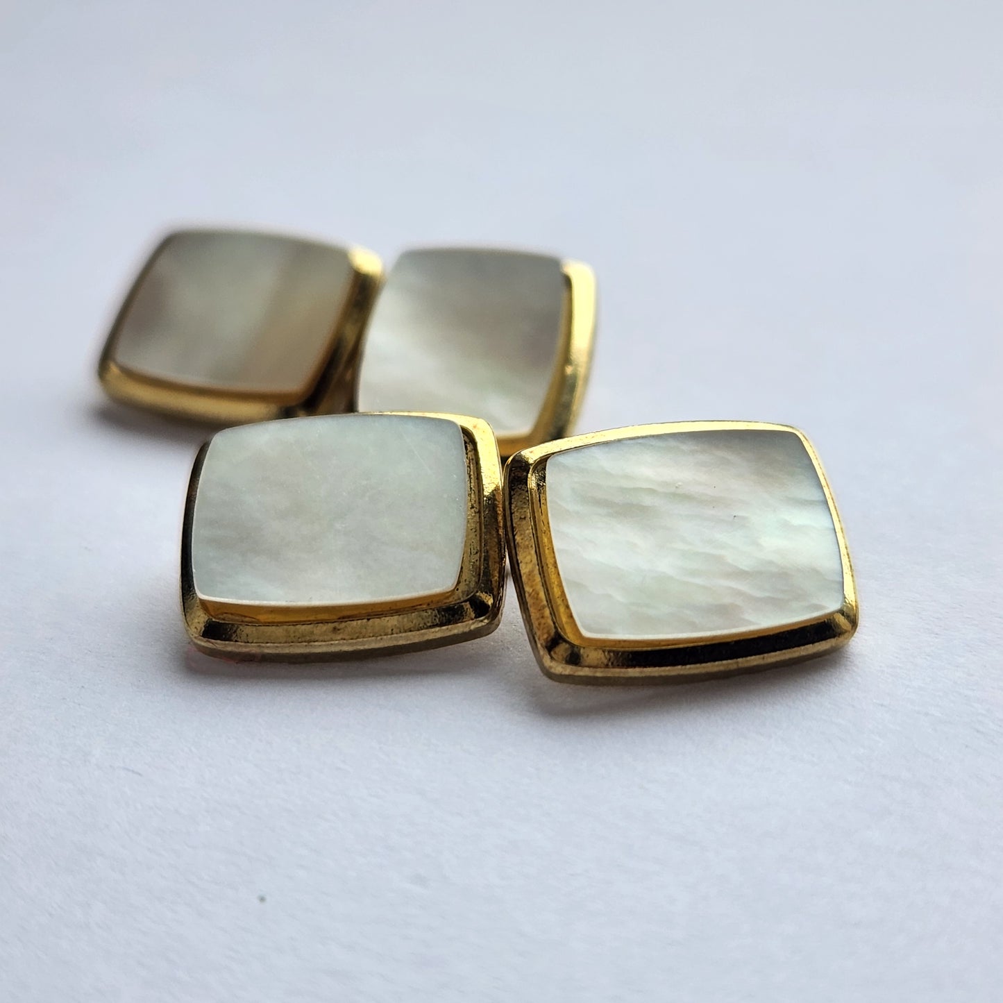 Small mother of pearl cufflinks in gold-tone metal from the front