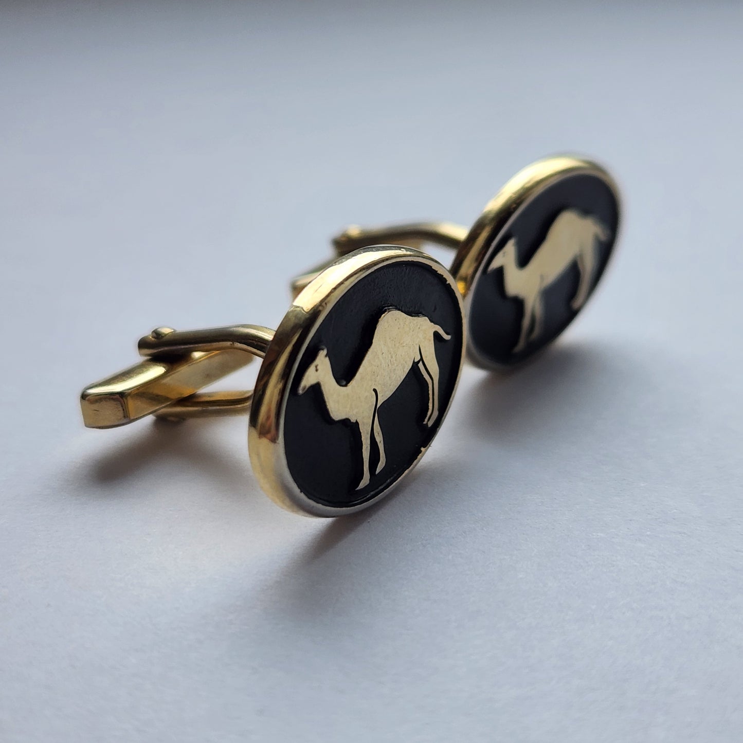 vintage cufflinks with a camel design from one side